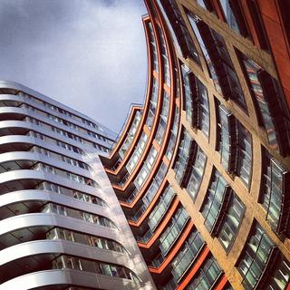 An angled view of a modern office block showing off its curves