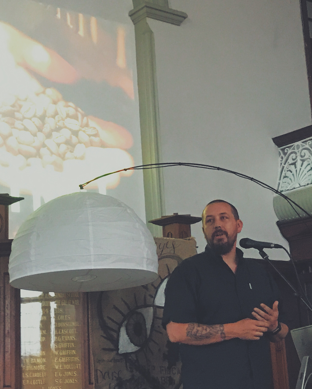 A man speaking into a microphone in a church