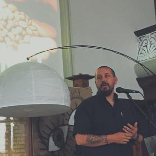 A man speaking into a microphone in a church