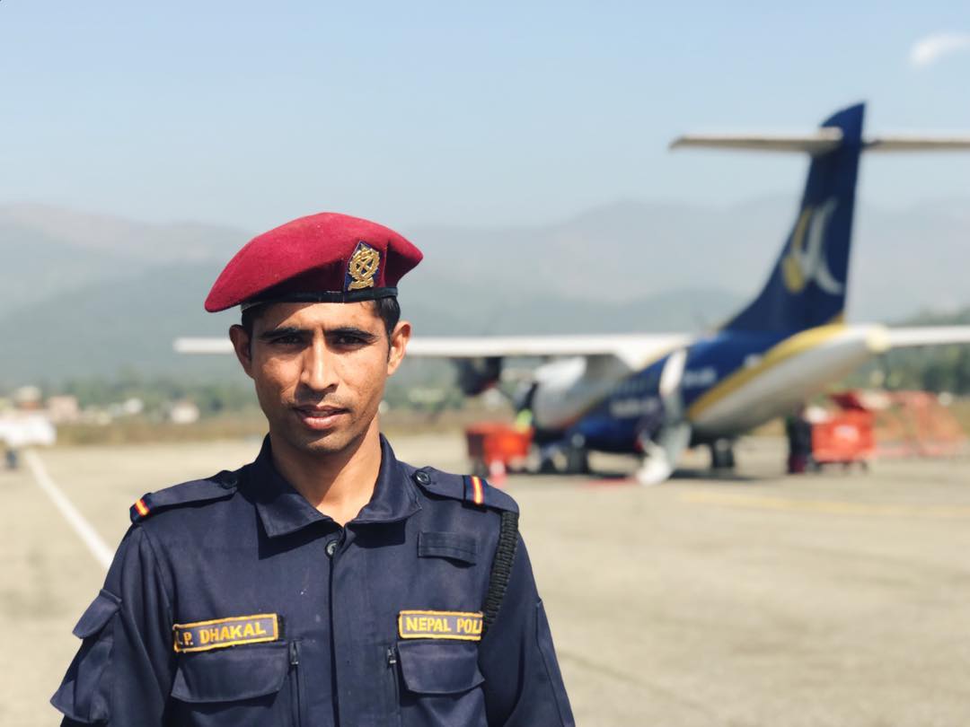 A police man standing in front of a plane