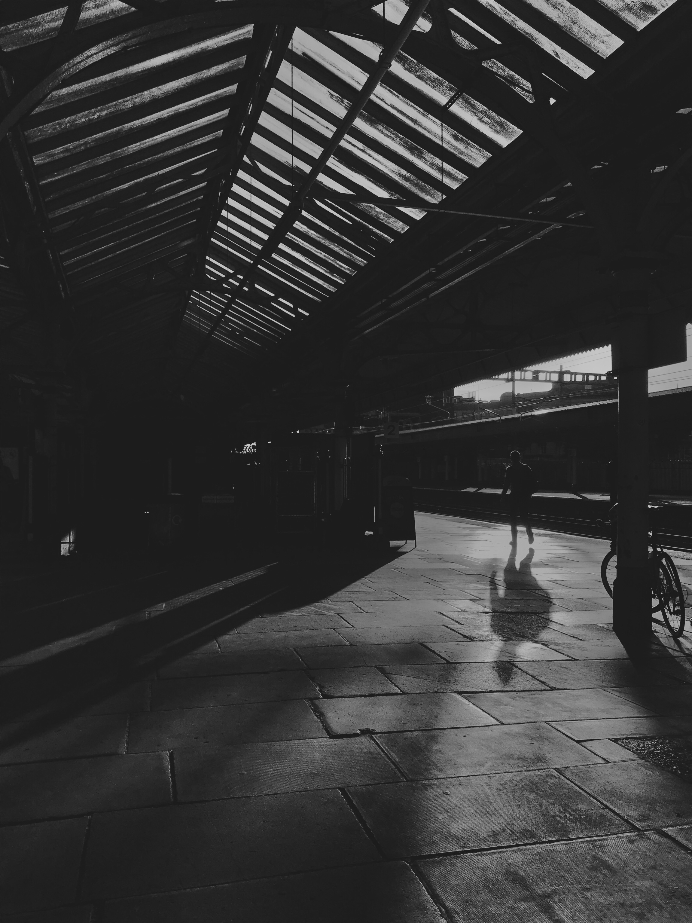 People waiting for a train at a railway station. 