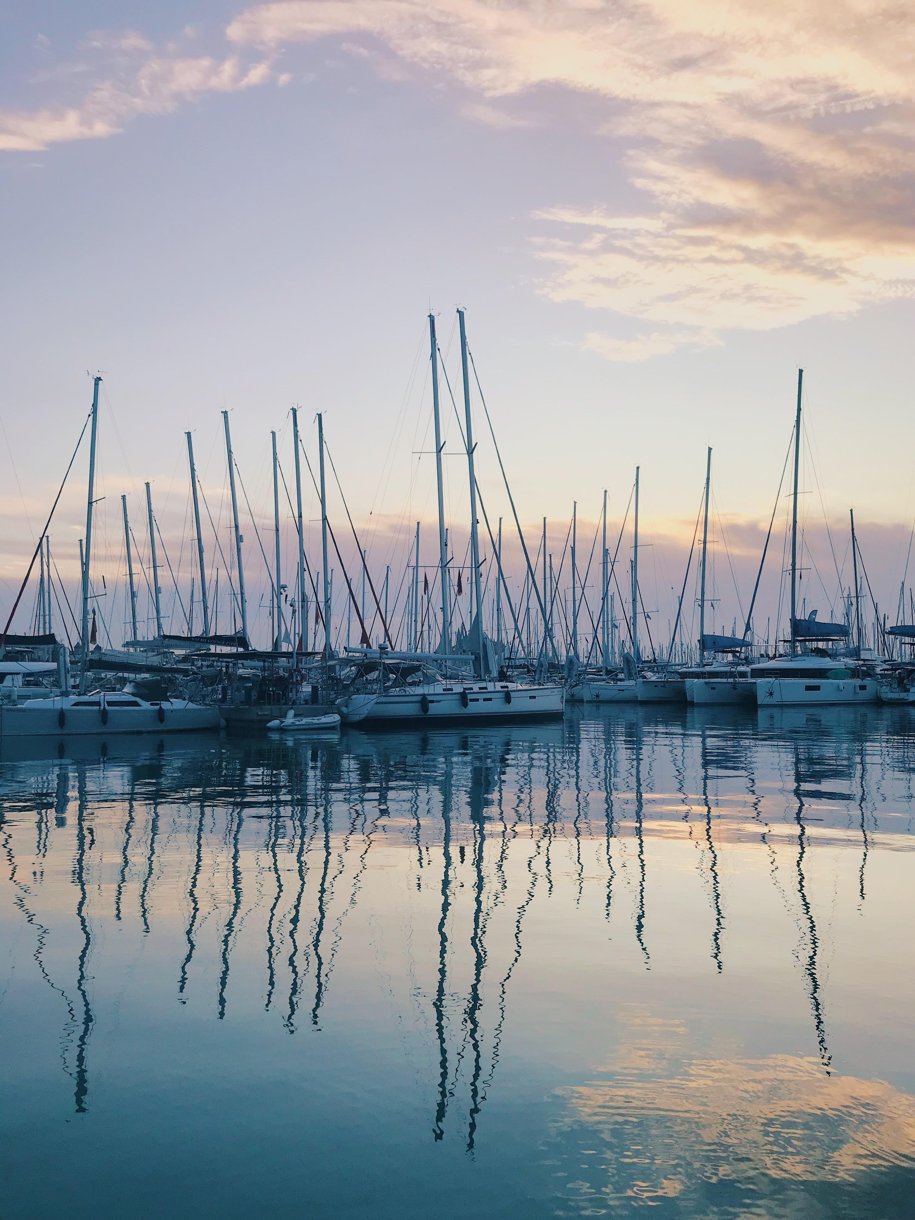 Reflections of boats in a mariener in the early morning light