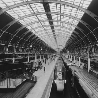 A train waiting under the curved roof in Paddington railway station
