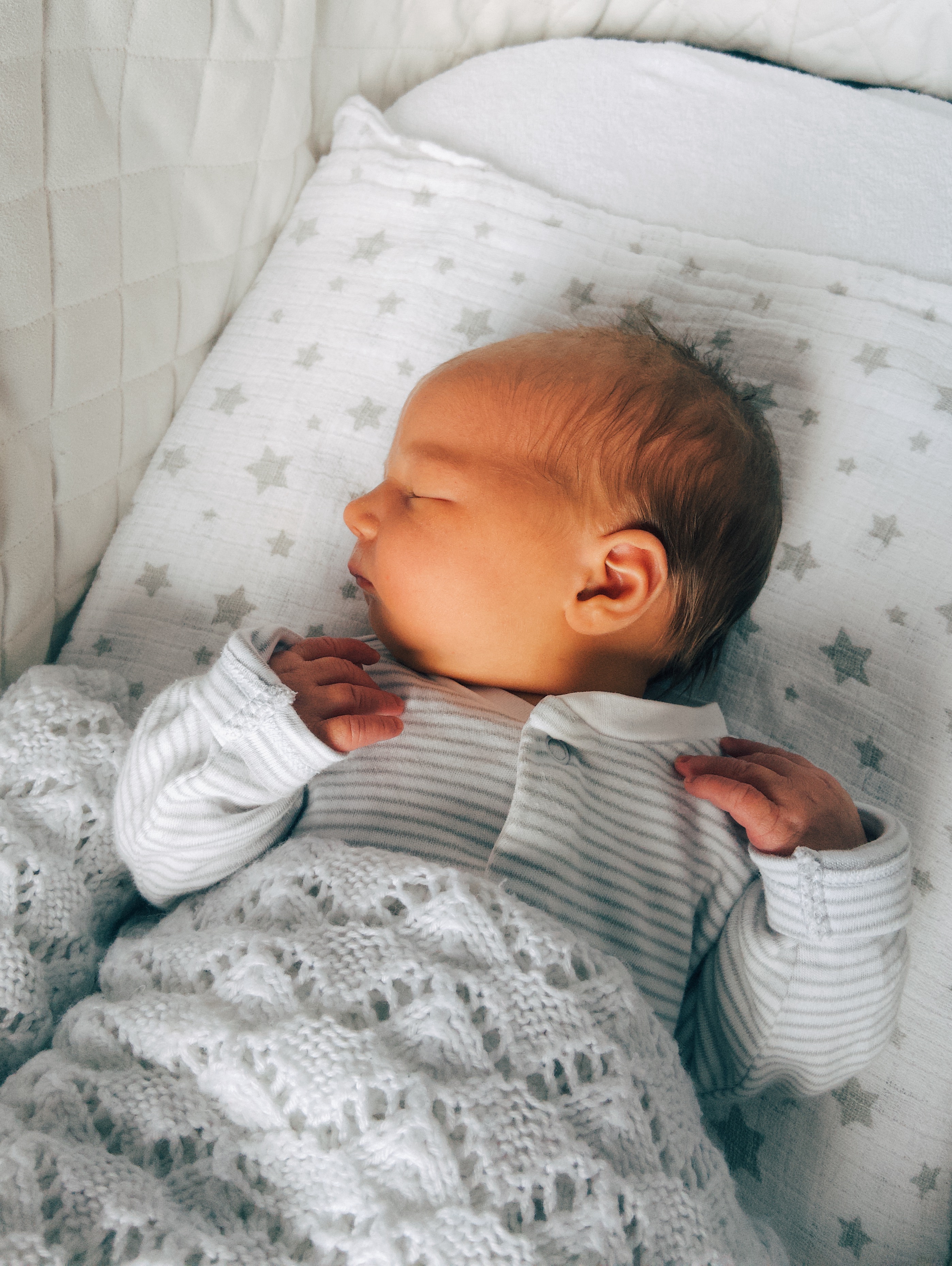 Baby asleep in her Moses basket